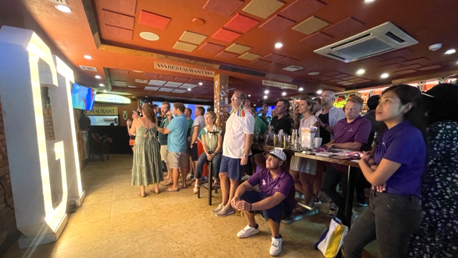 Client and staff watching game.